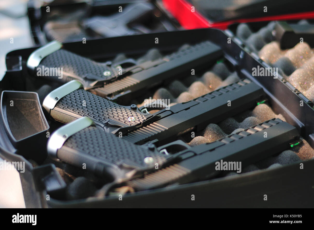Airsoft guns laid out in gun case. Stock Photo