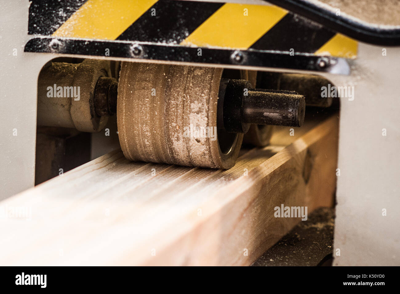 Woodworking machine with plane during processing. Machine tool in factory. close Stock Photo