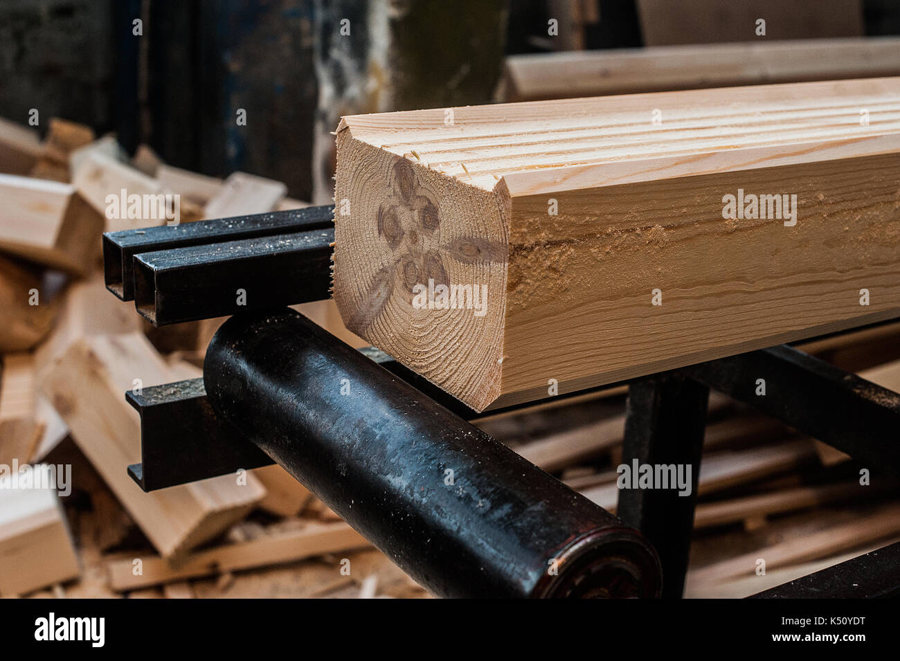 Fresh wooden beam, stacked at construction site. The surface of the processed wooden beam. at the exit Stock Photo