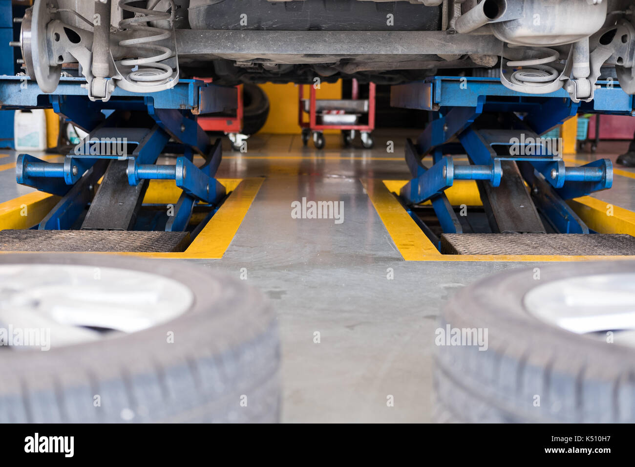 undercarriage of a car in garage. vehicle maintenance in auto repair