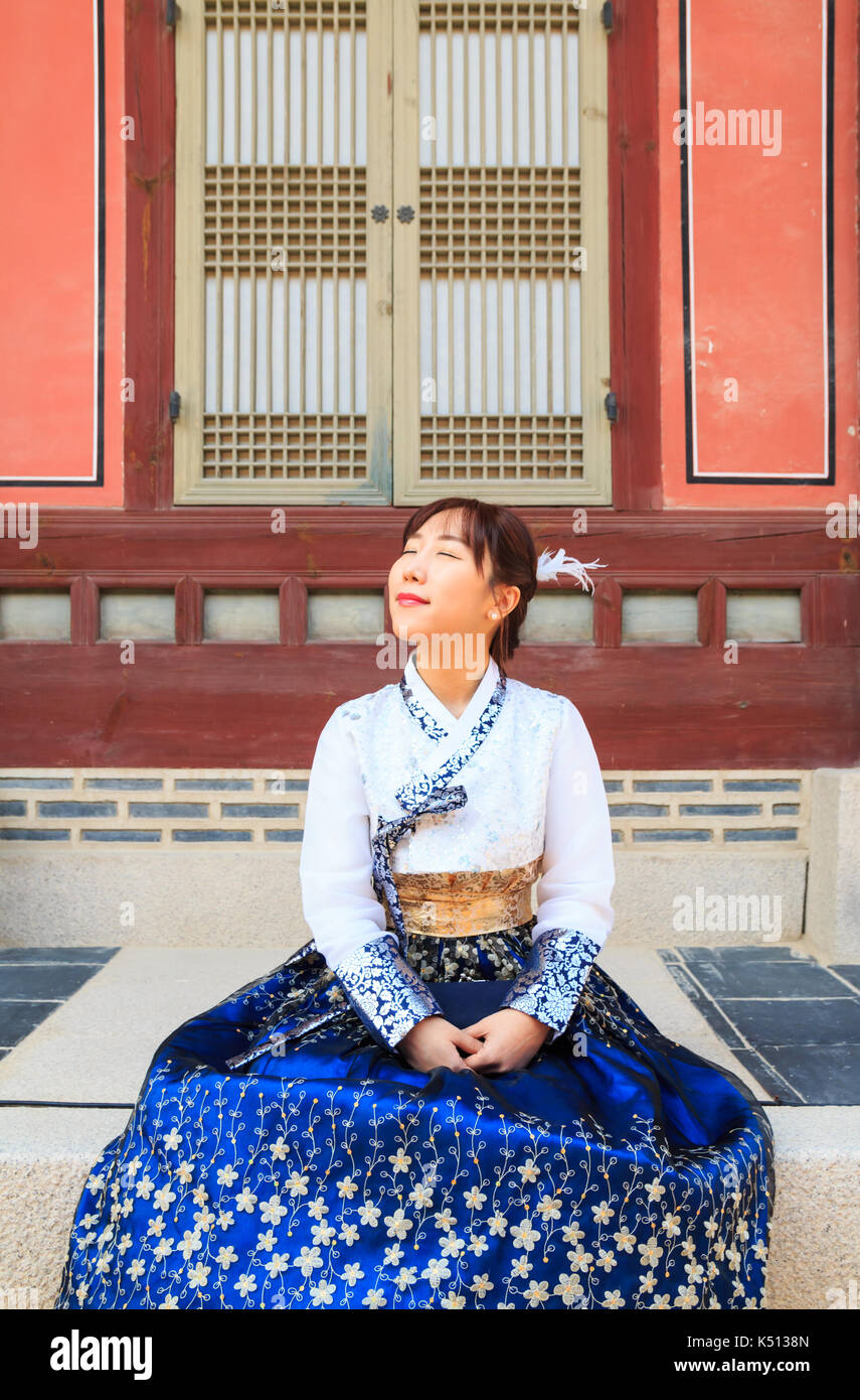 Beautiful Korean woman dressed Hanbok, Korean traditional dress, in Gyeongbokgung Palace, Seoul, South Korea Stock Photo