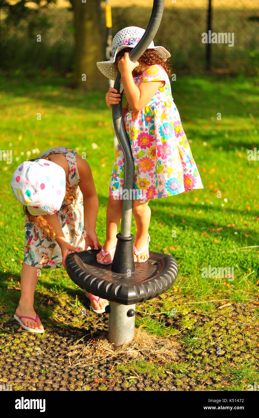 Two young girls on playground during summer in the UK Stock Photo - Alamy