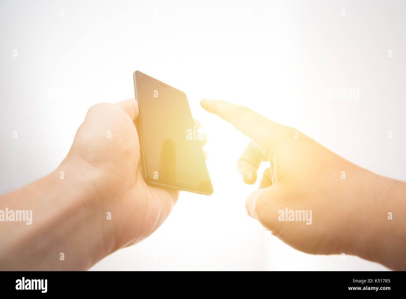 Technology in your hand concept. Hand hold smart phone with touching with finger. Stock Photo