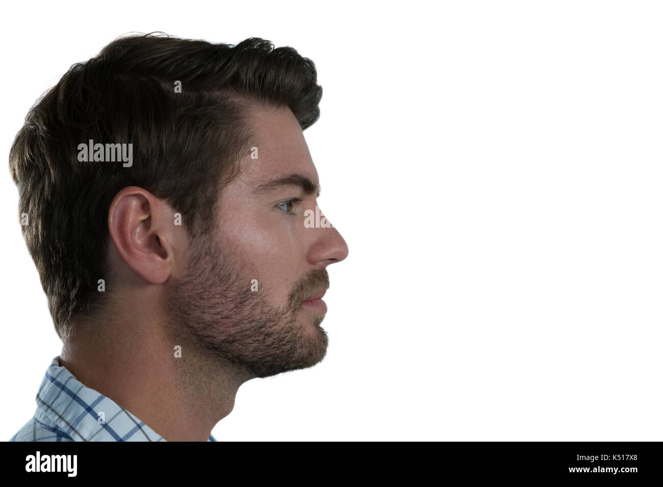 Side view of man standing against white background Stock Photo - Alamy