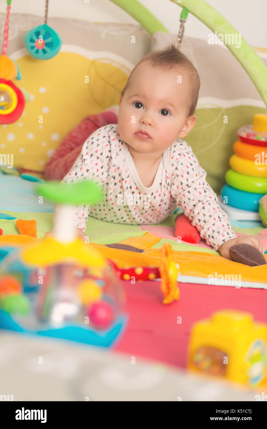 Eight months old baby girl playing with