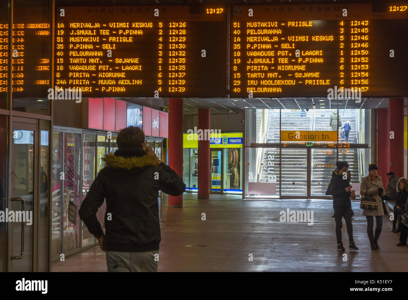 Watching bus timetables at Viru Keskus bus terminal in Tallinn Estonia Stock Photo