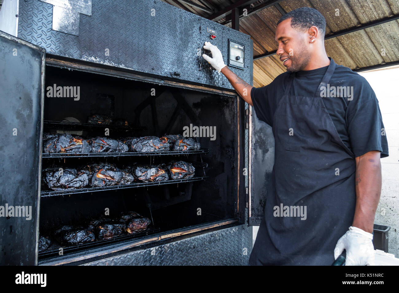 Georgia,St. Simons Island,Southern Soul Barbeque, restaurant,BBQ,outdoor smoker,Black,man men male,cook,cooked meat,USA US United States America North Stock Photo