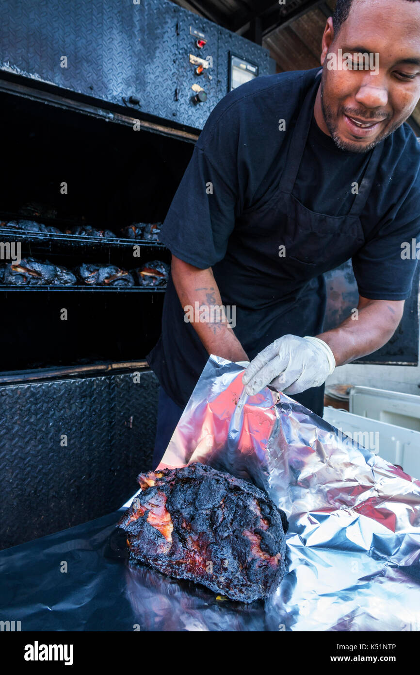 Georgia,St. Simons Island,Southern Soul Barbeque, restaurant,BBQ,outdoor smoker,Black,man men male,cook,cooked meat,USA US United States America North Stock Photo