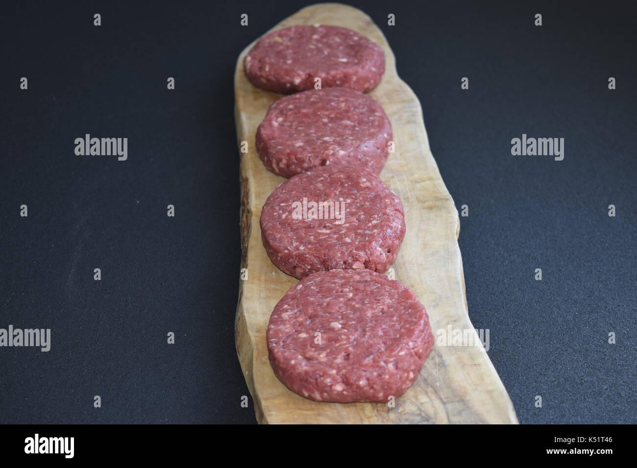 Raw meat on a wooden surface ready to cook Stock Photo