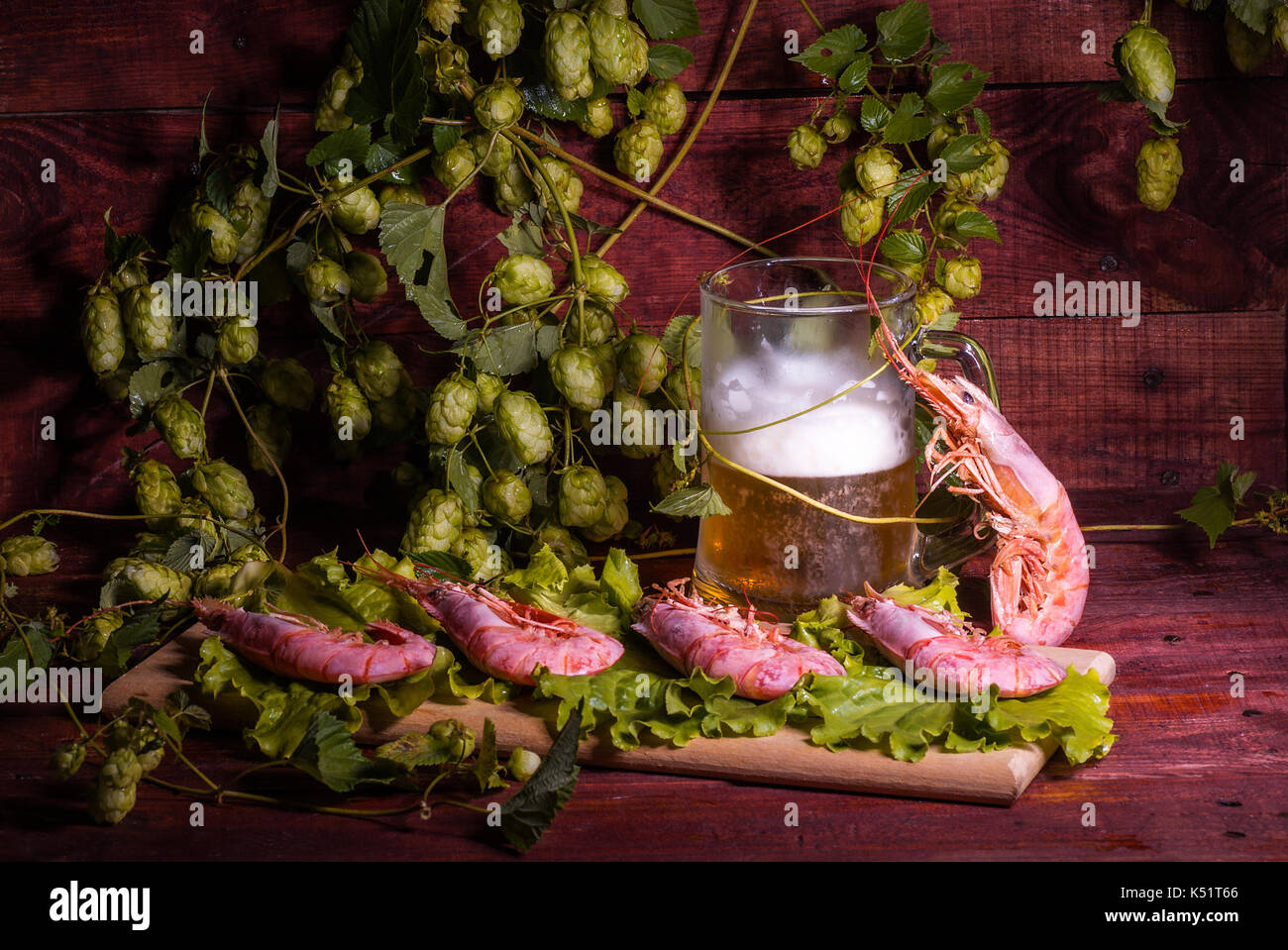 Beer with shrimps and salad on a wooden table Stock Photo