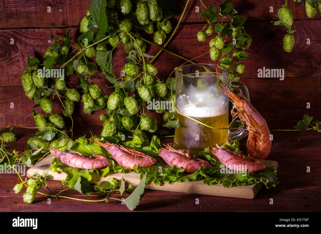 Beer with shrimps and salad on a wooden table Stock Photo