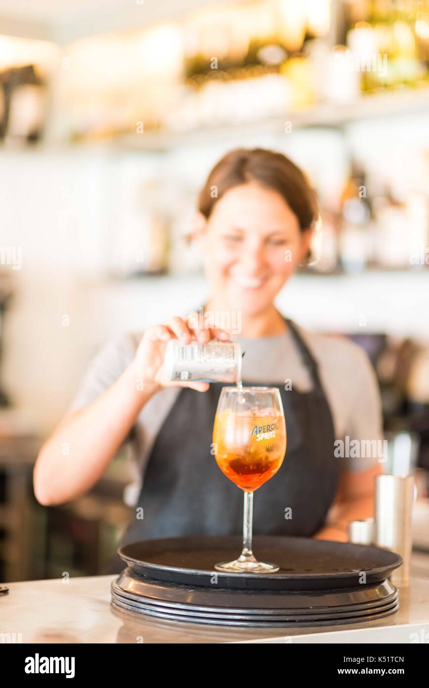 A female bartender pouring a drink Stock Photo