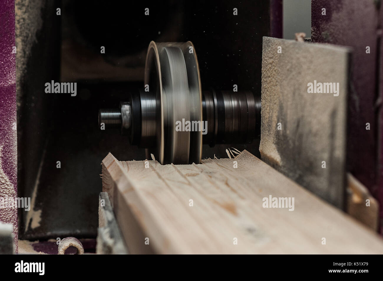The machine for sampling the groove in a wooden beam with a milling cutter for vertical grooving. in progress. ib front Stock Photo