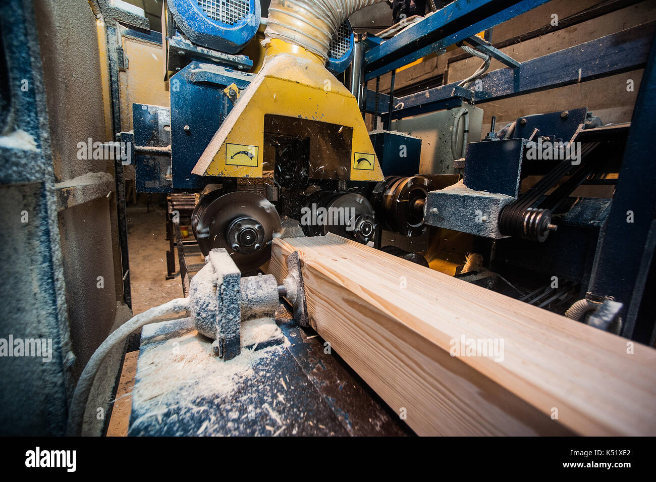The machine for sampling the groove in a wooden beam. in progress from afar Stock Photo