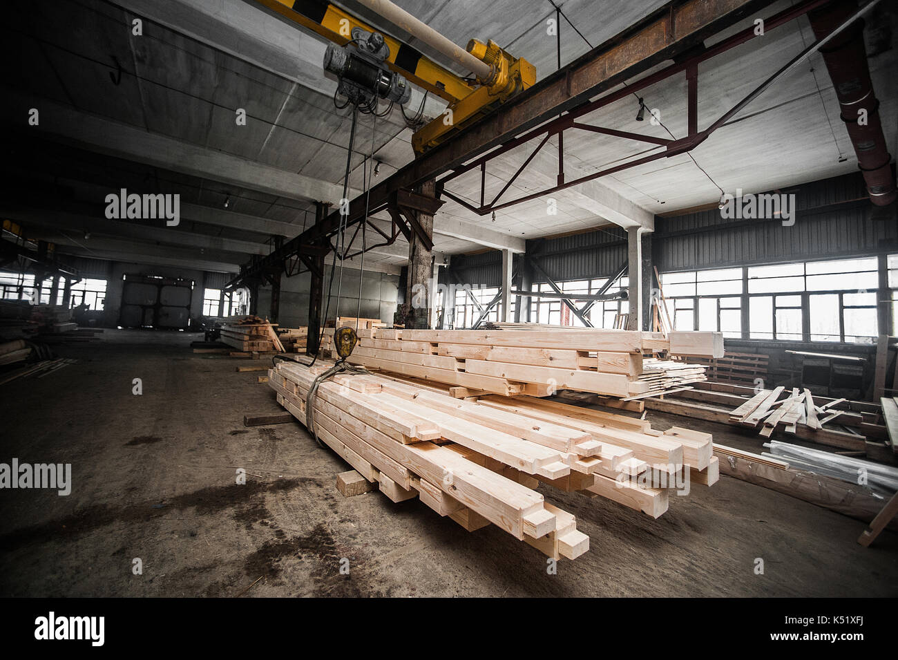 Stack wood beams in the factory. A stack of new processed bars in the production hall. another view Stock Photo
