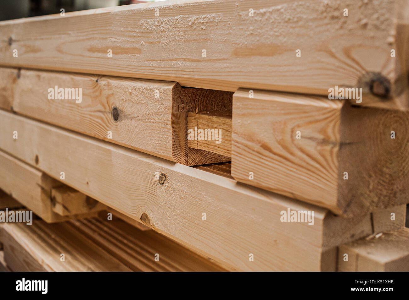 Stack wood beams in the factory. A stack of new processed bars in the production hall. closeup Stock Photo