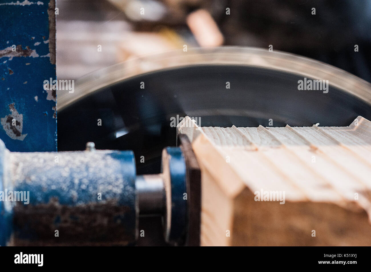 Circular saw with a wooden beam and measuring scale. Sawing a wooden beam with a circular saw. close up at exit Stock Photo