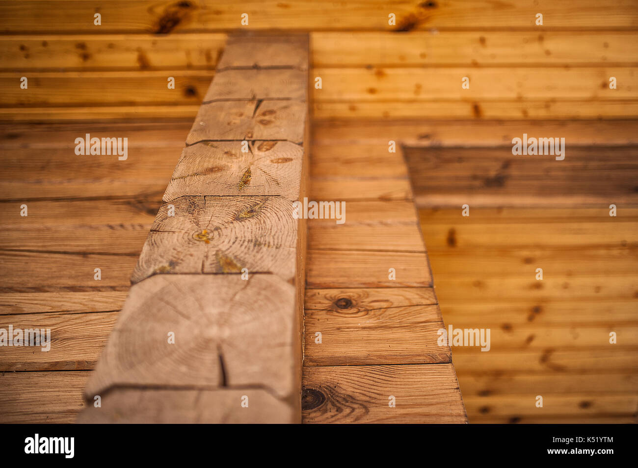 Texture - wooden boards brown color. Texture of a wooden wall from a bar. at intersection another view from afar Stock Photo
