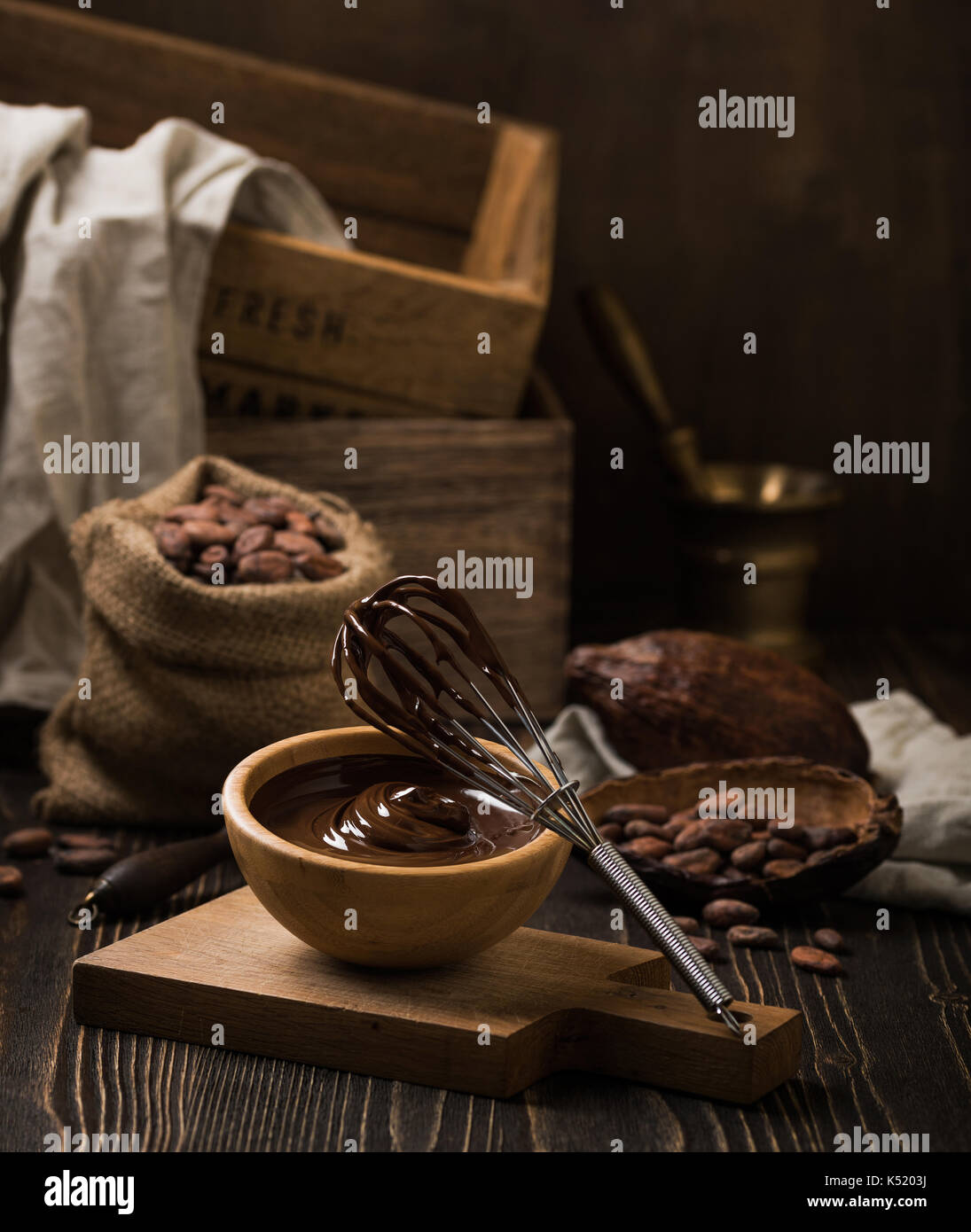 Melted chocolate in wooden bowl Stock Photo