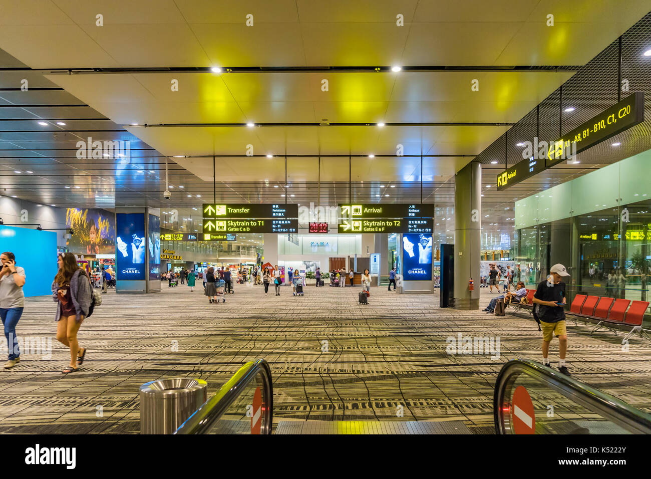Passengers at Singapore Changi airport terminal 4 departures counter self  check in area Stock Photo - Alamy