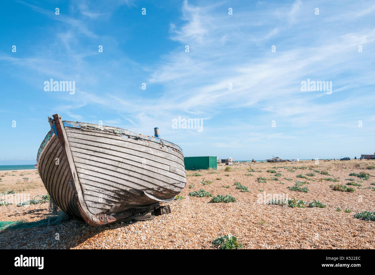 A boat beached on the shingle of Dungeness beach Stock Photo - Alamy