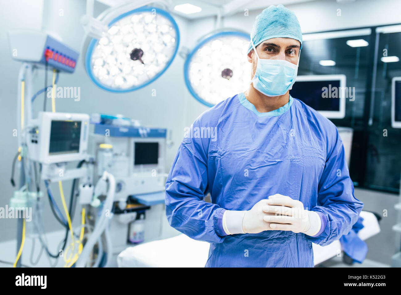 Portrait of male surgeon in operation theater looking at camera. Doctor
