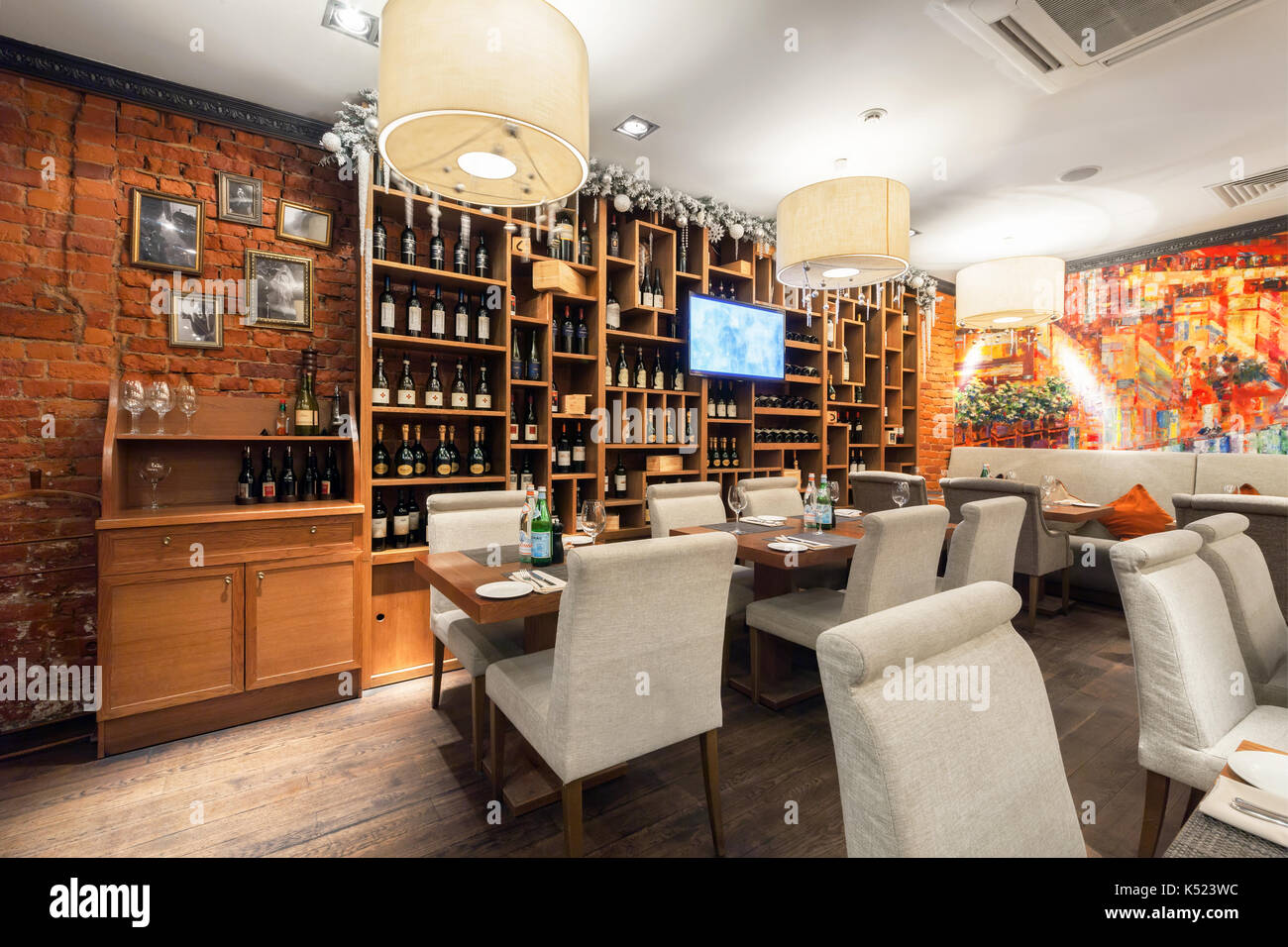 The interior of the main hall luxurious Italian restaurant - il FORNO. Wooden wine rack Stock Photo