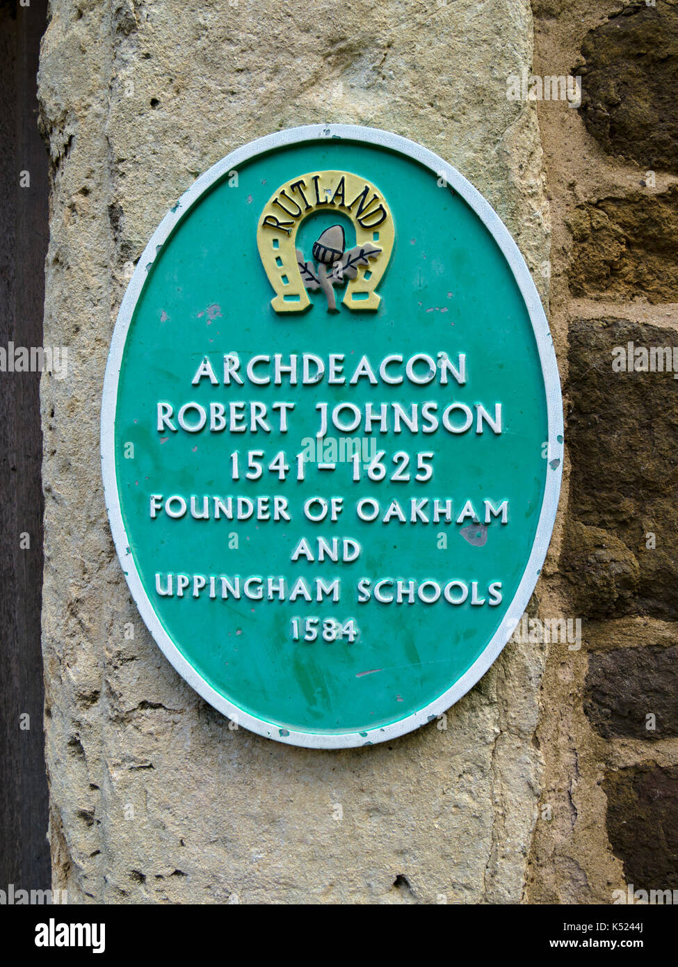 Oval metal wall plaque to Archdeacon Robert Johnson, the founder of Oakham and Uppingham Schools, Uppingham, Rutland, UK Stock Photo