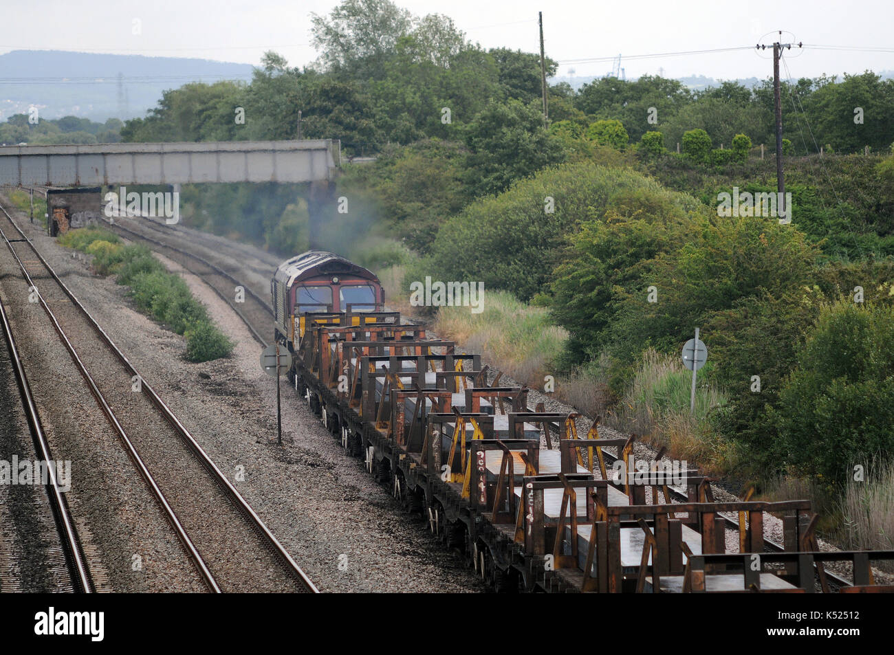 66198 heads east at Marshfield with a train of steel slabs. Stock Photo