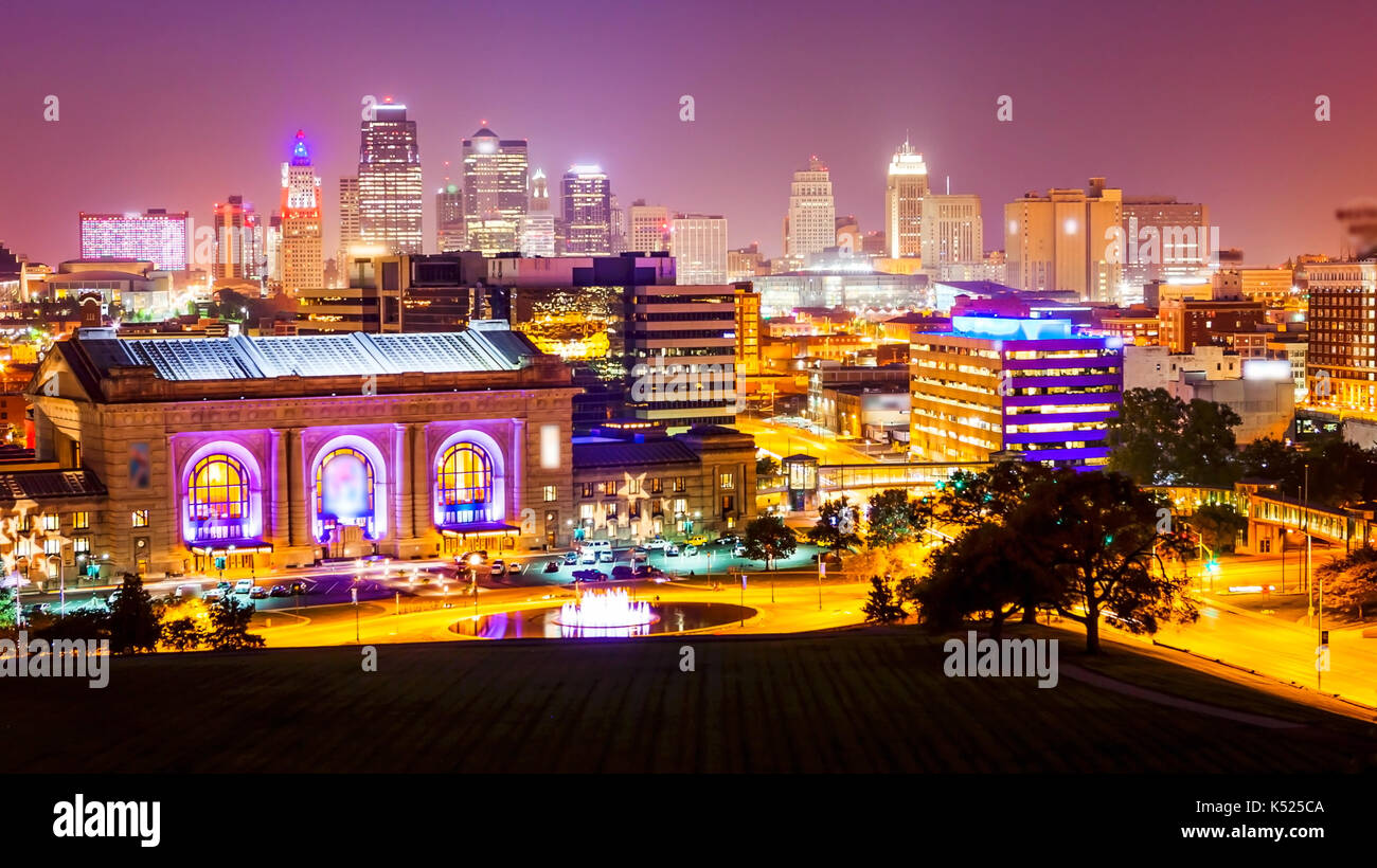 Kansas City, Missouri cityscape skyline as night falls over downtown (logos blurred for commercial use) Stock Photo
