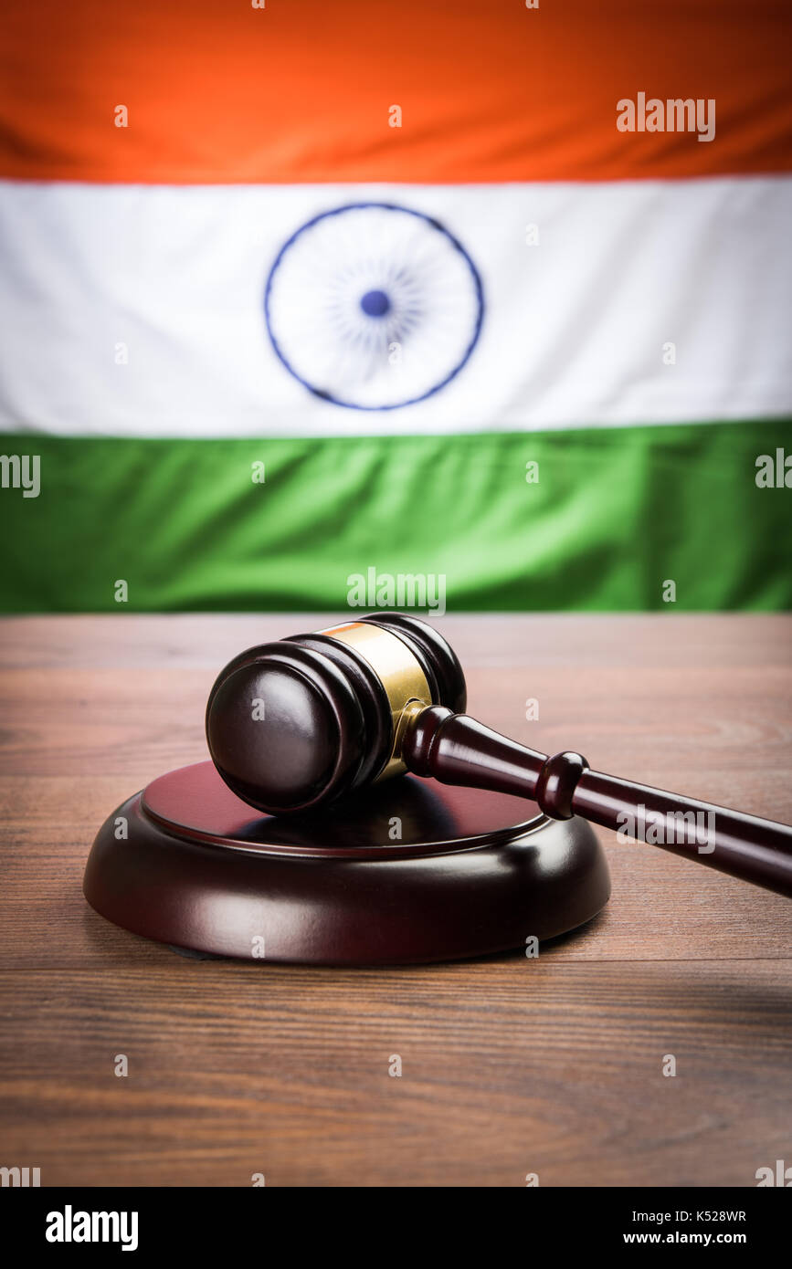 stock photo showing Indian low and jurisdiction - Indian national flag or tricolour with wooden gavel showing concept of law in India Stock Photo