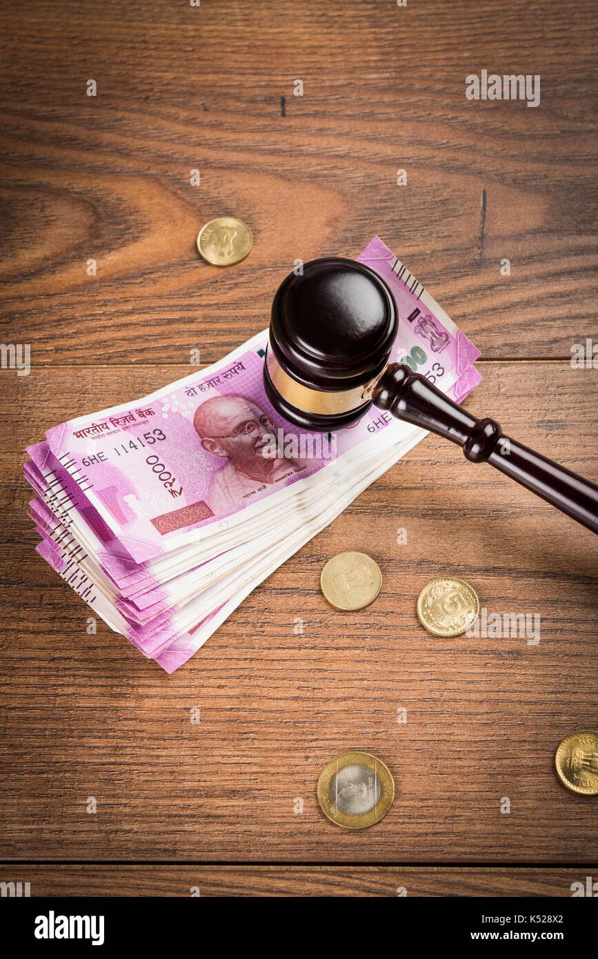 stock photo of Indian Currency Rupee Notes with Law Gavel isolated on white, concept showing indian finance law with paper currency of 500,2000 with g Stock Photo
