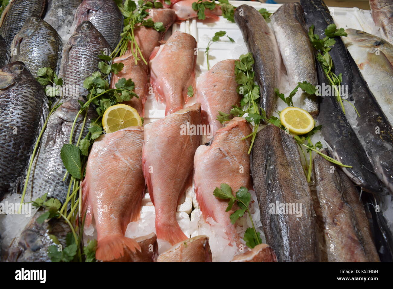 Uncooked varieties of fish on a market stall Stock Photo