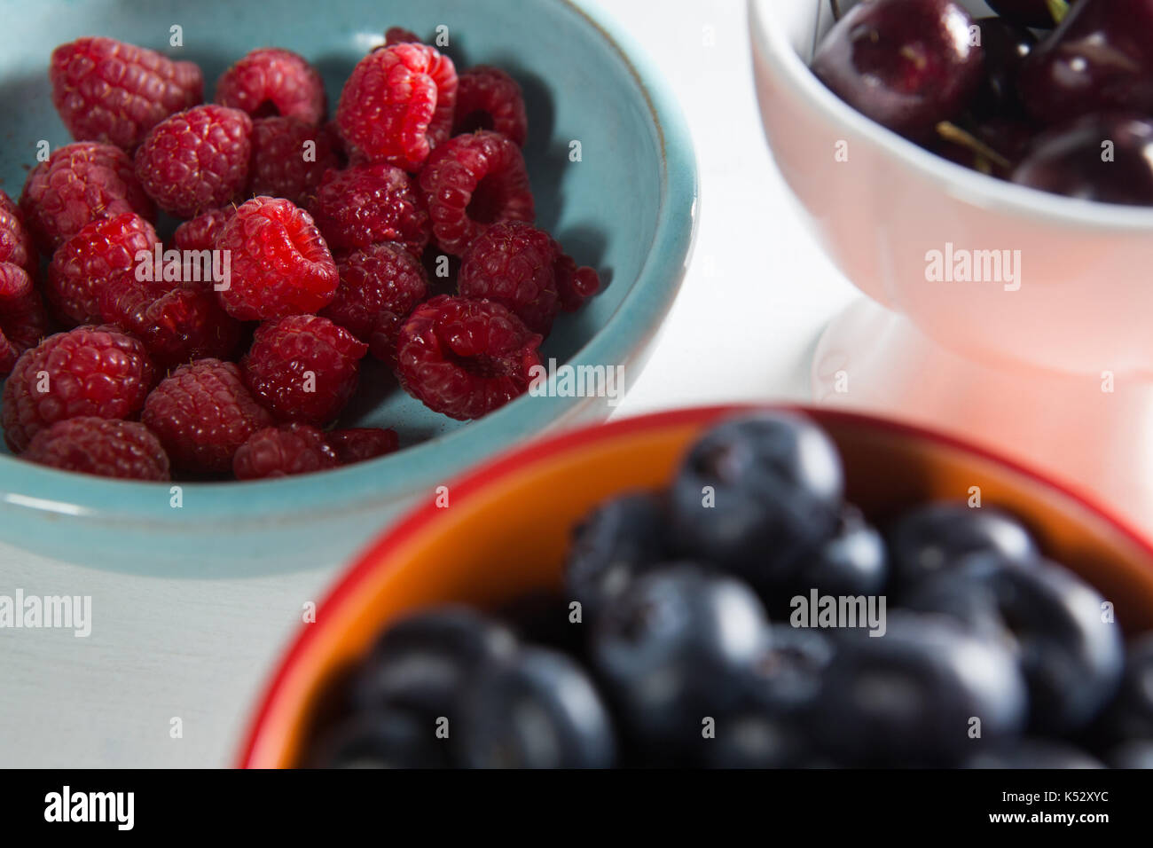 Closeup of berries and cherries in bowls Stock Photo Alamy