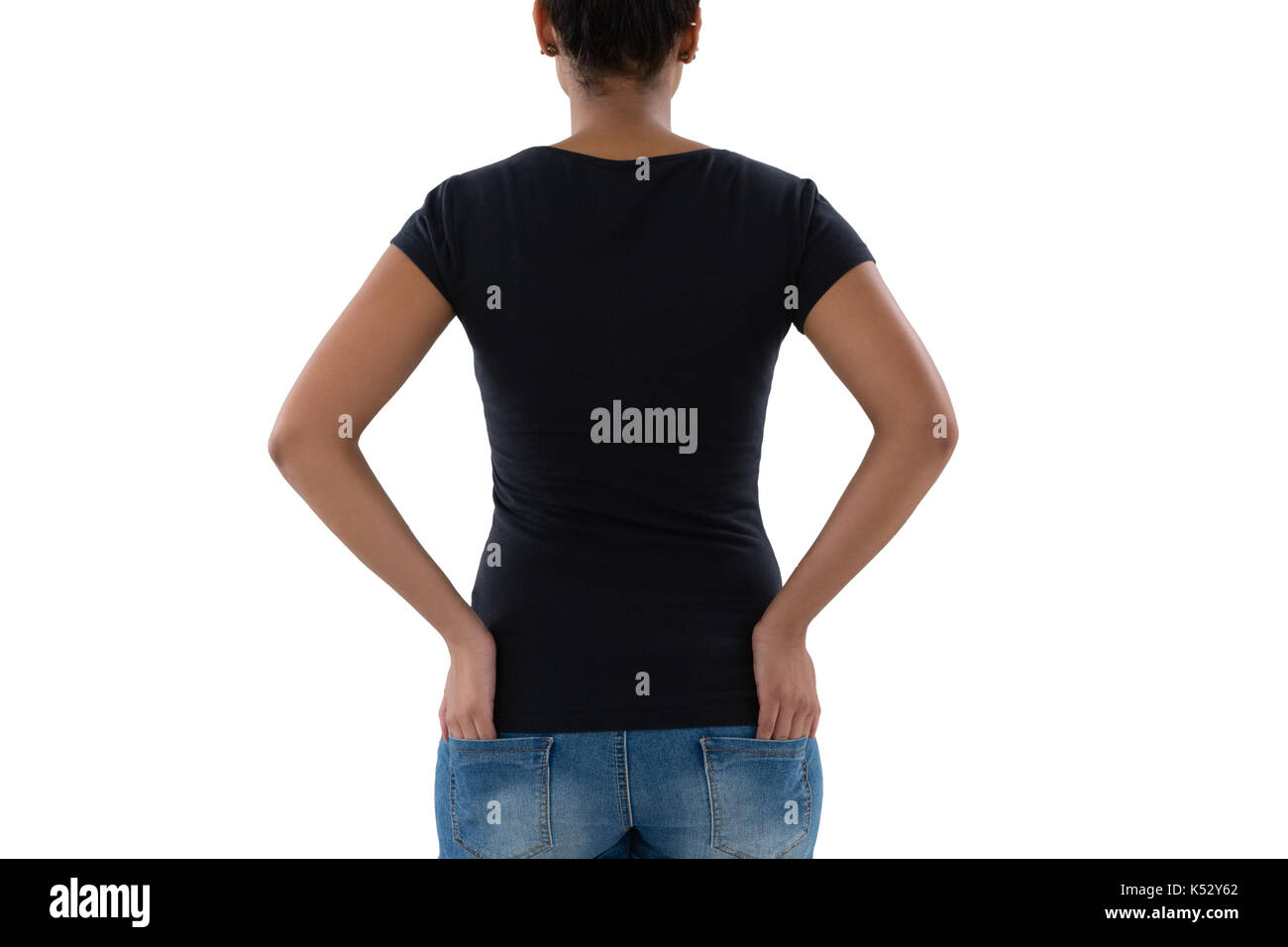 Rear view of woman with hands in pockets against white background Stock ...