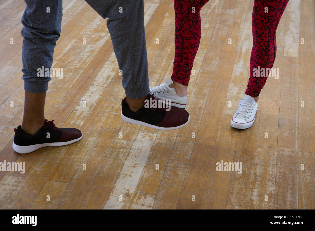 Low section of dancers practicing on floor in studio Stock Photo