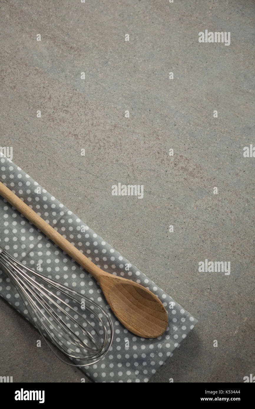Wooden spoon with wire whisk on napkin at table Stock Photo Alamy