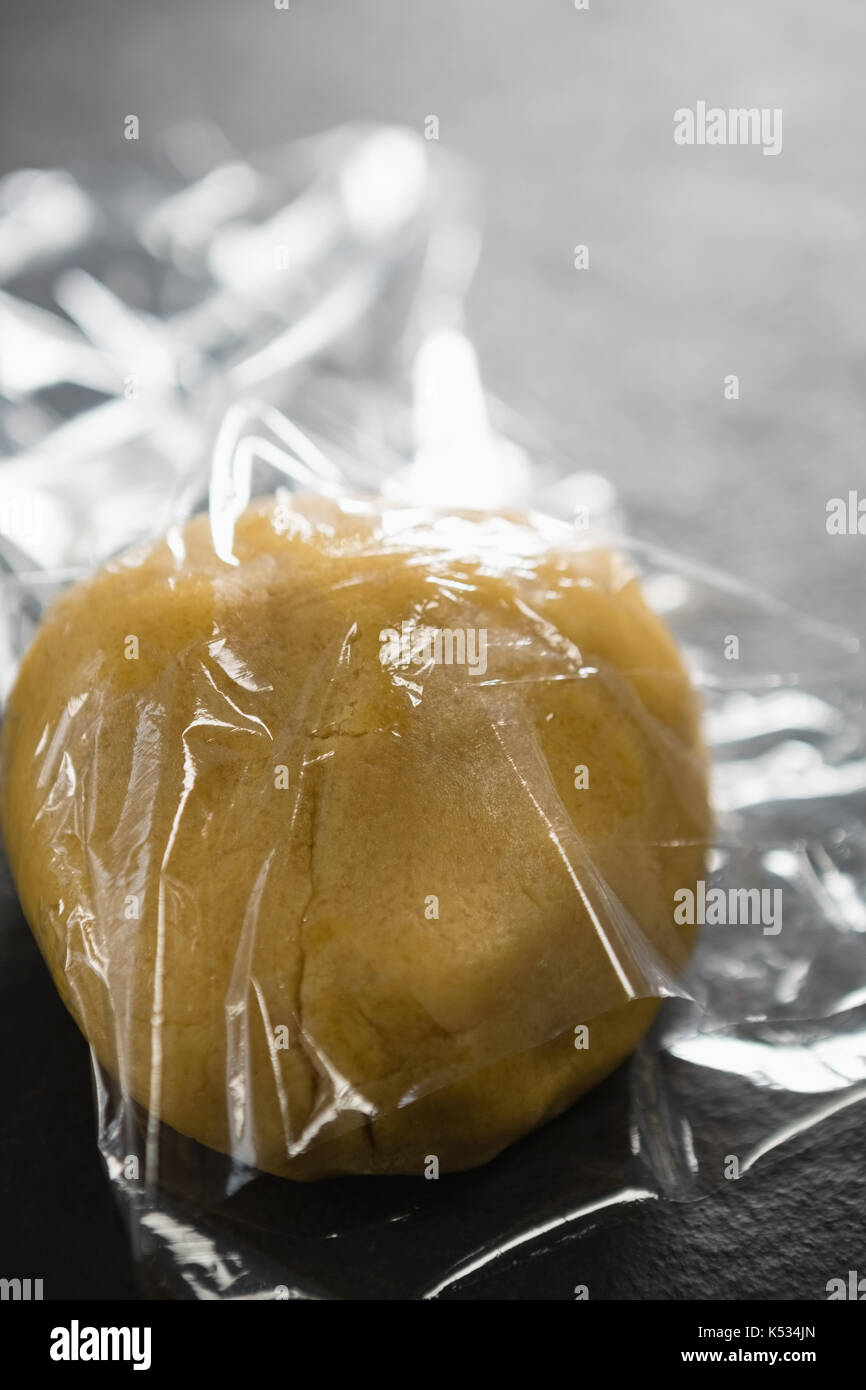 High anlge view of dough in plastic wrap on table Stock Photo Alamy