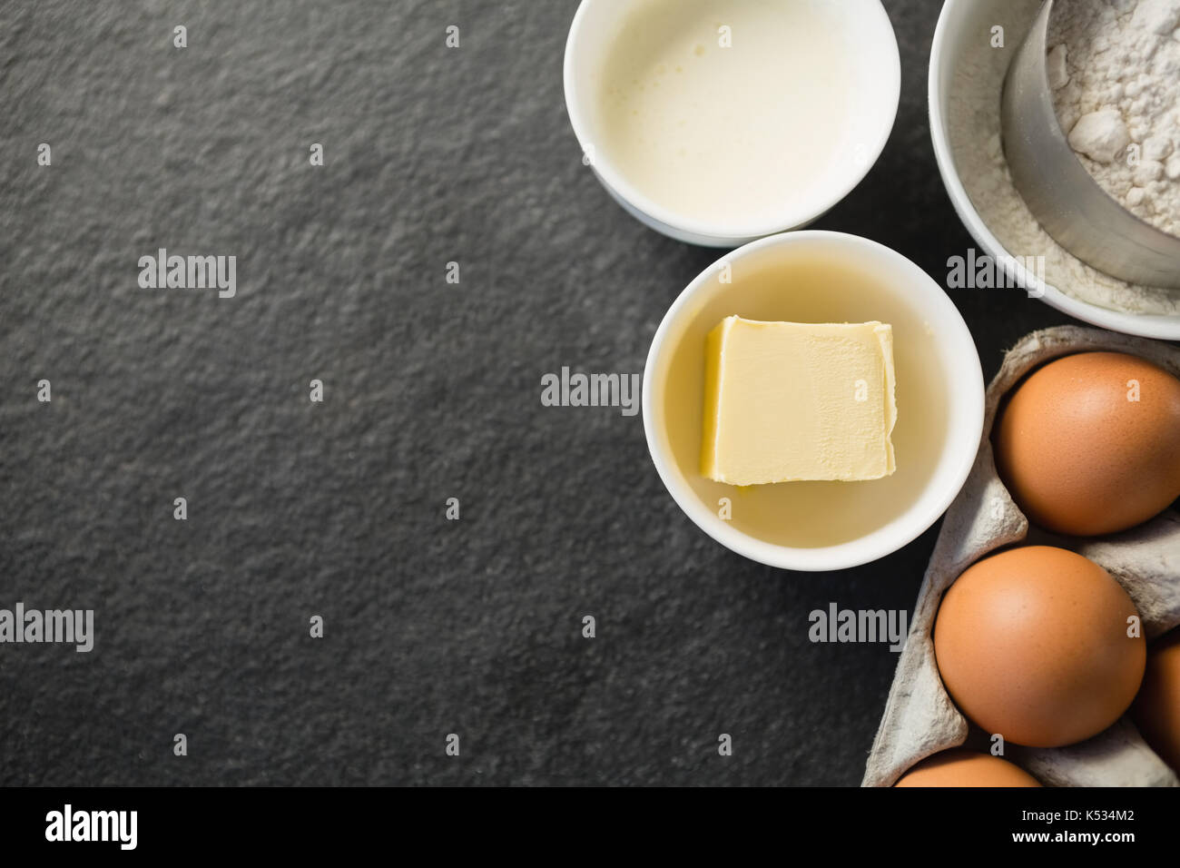 Overhead view of butter in bowl by ingredients on table Stock Photo