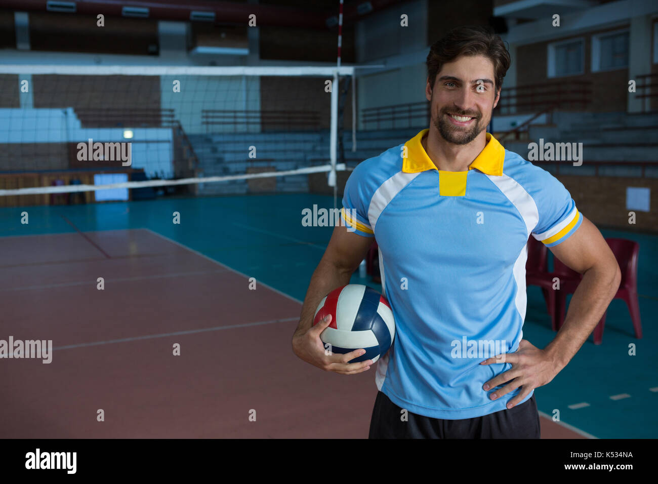 Professional sportsperson sitting smiling holding sports venue hires