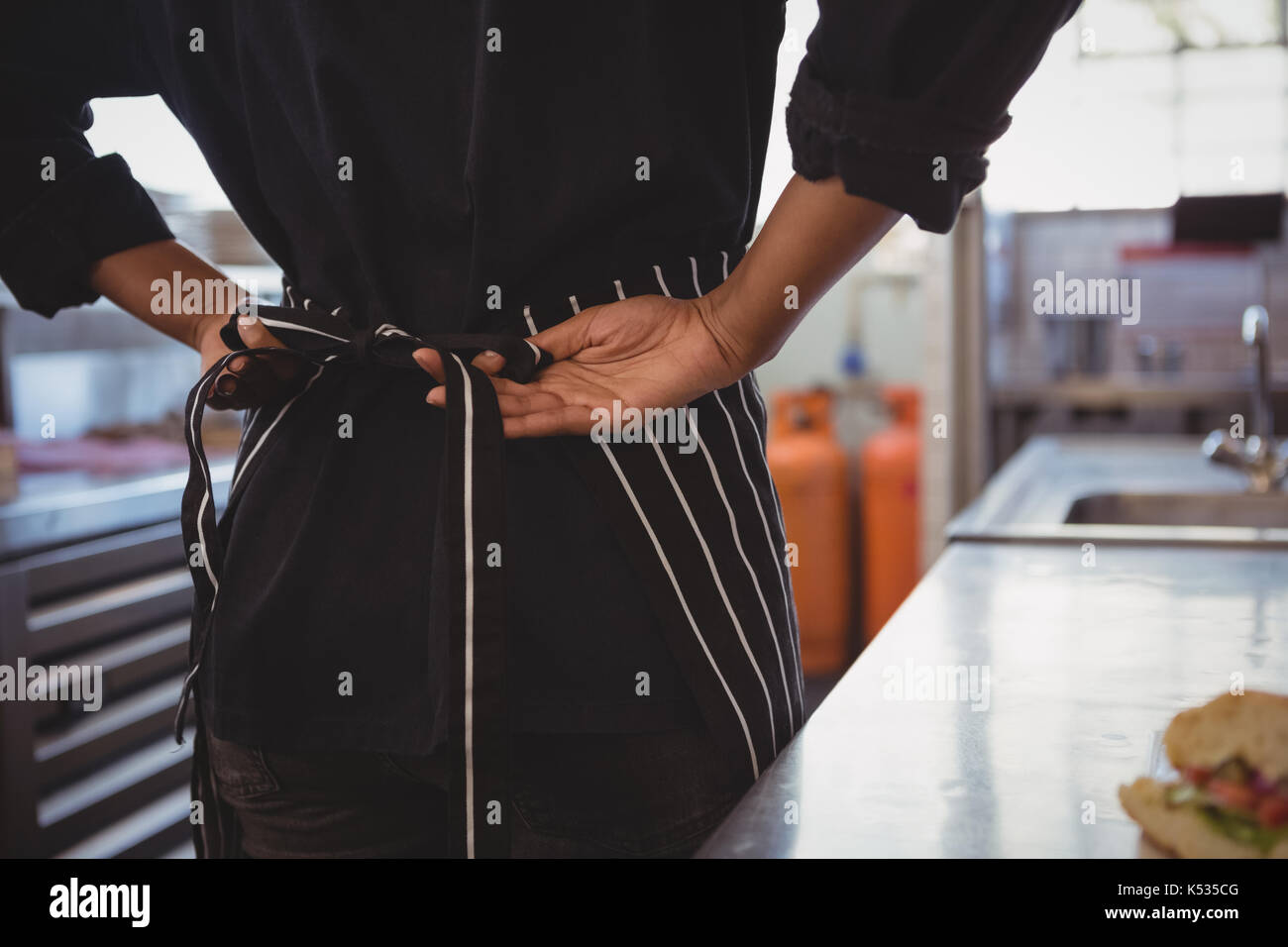 Waiter wearing apron hi-res stock photography and images - Alamy