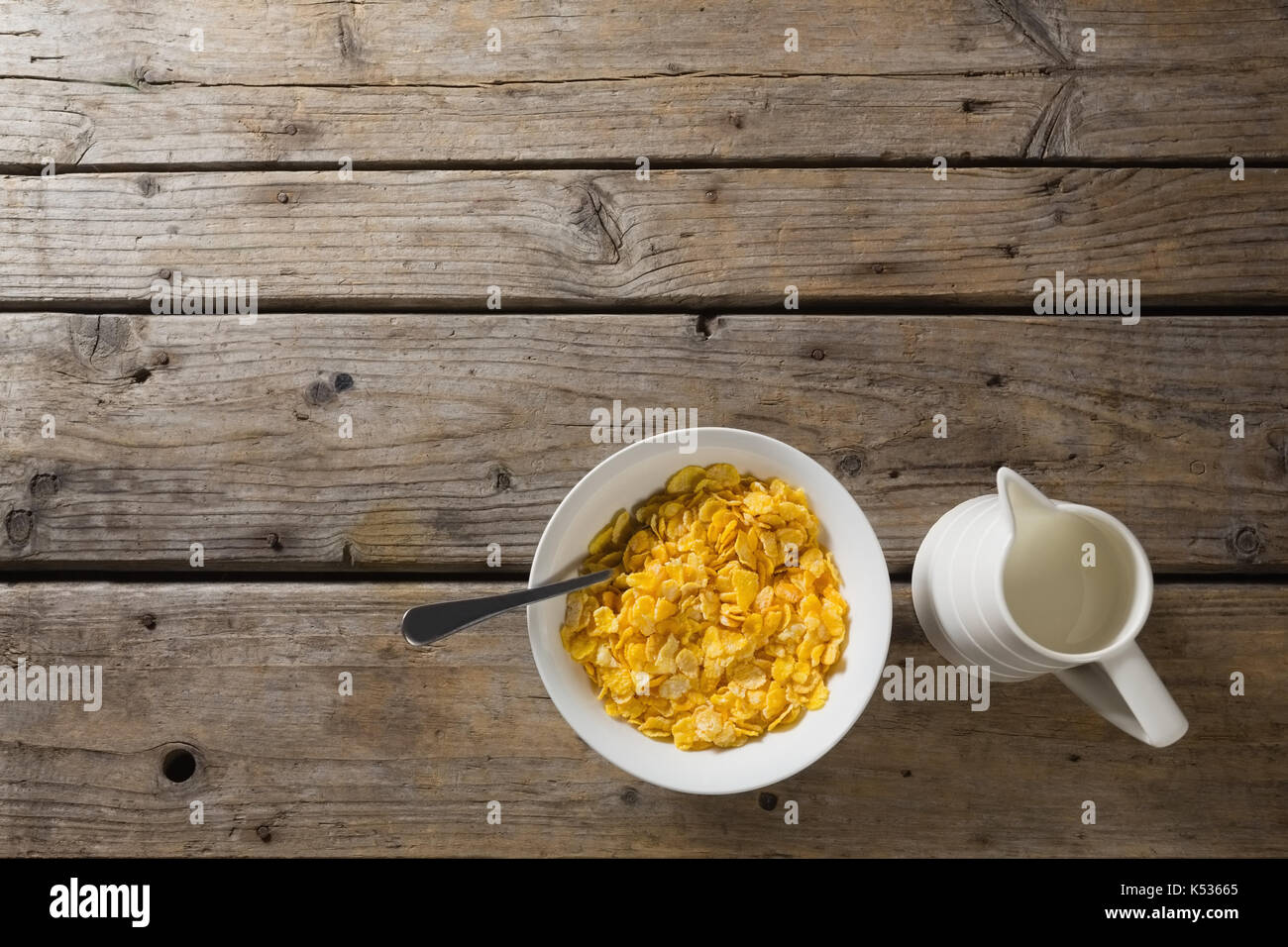 Bowl of wheaties cereal and milk with spoon on wooden table Stock Photo