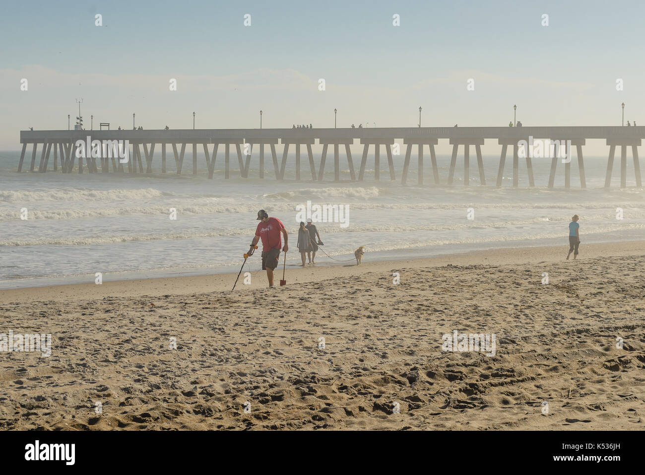 Man uses metal detector along Wrightsville Beach, NC. Stock Photo