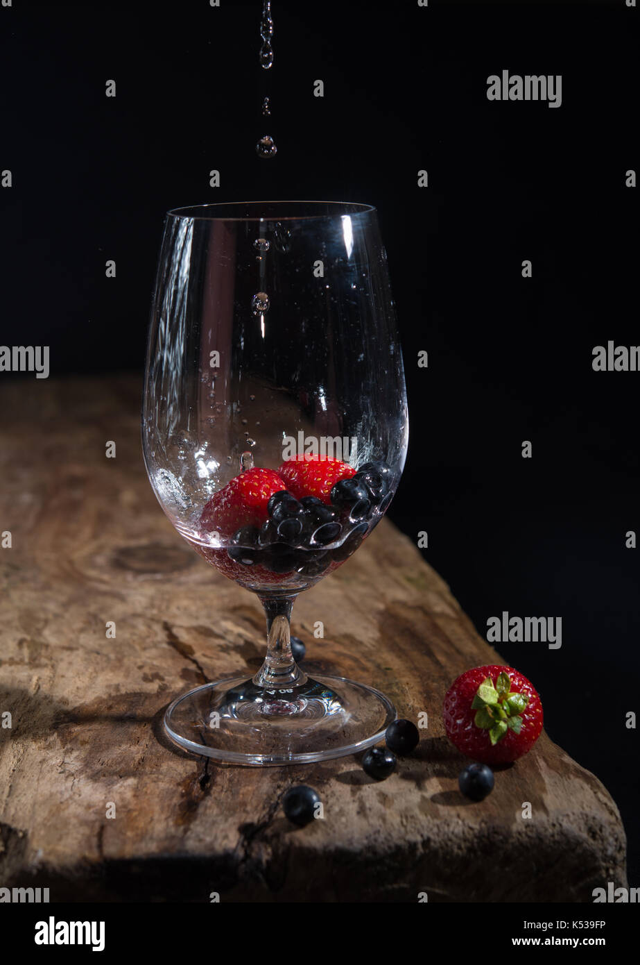 Fresh fruit in wine glass, water dripping, still life Stock Photo Alamy