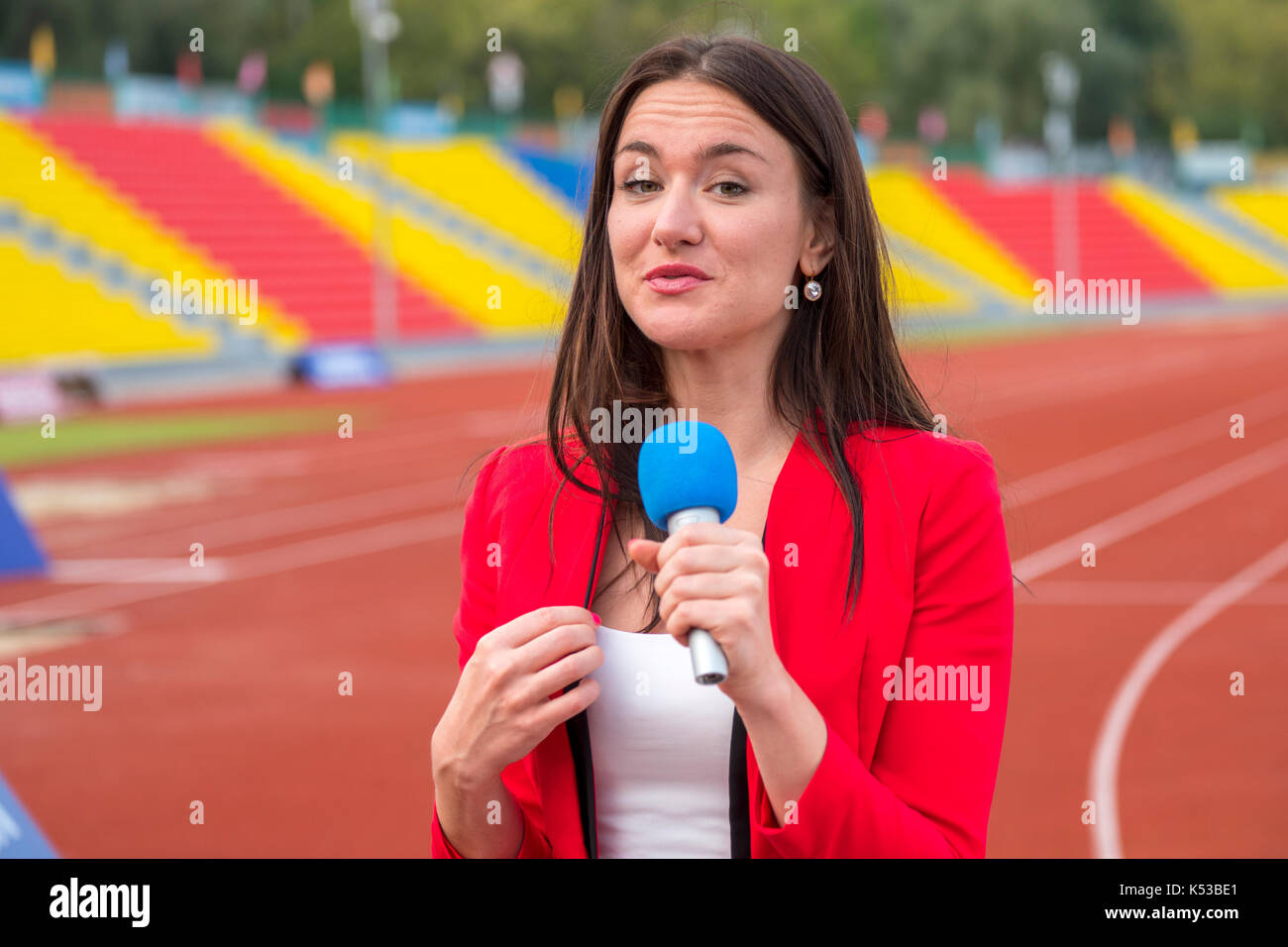 The journalist is reporting from the stadium for television Stock Photo ...