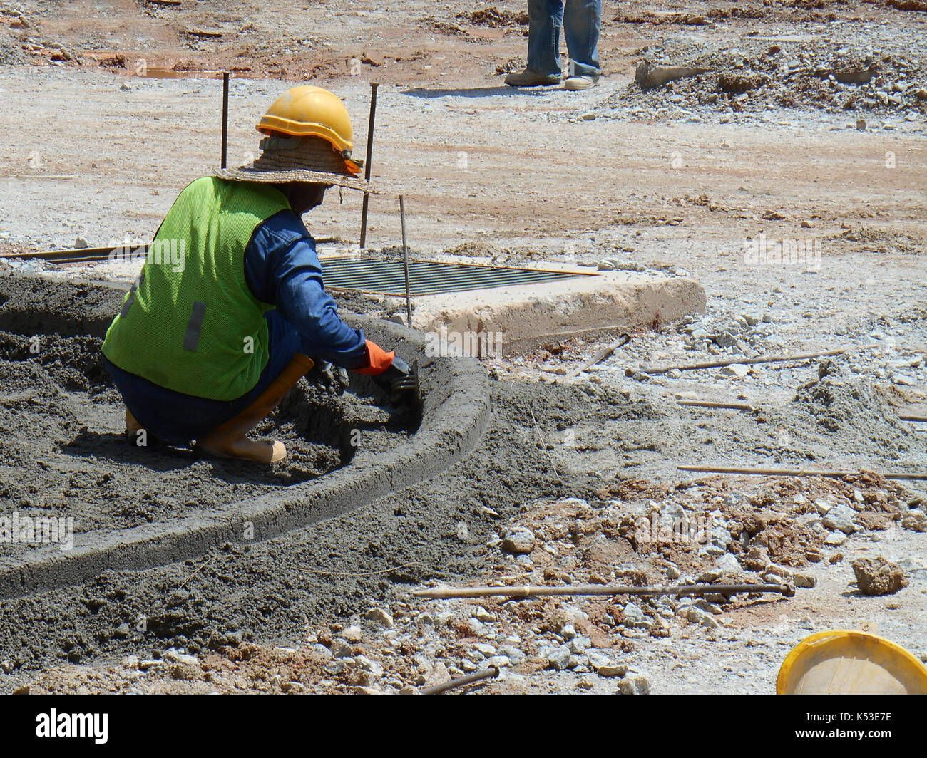 SEREMBAN, MALAYSIA -MAY 16, 2017: Construction workers fabricating concrete road kerb at the construction site. They are using in situ method and made Stock Photo