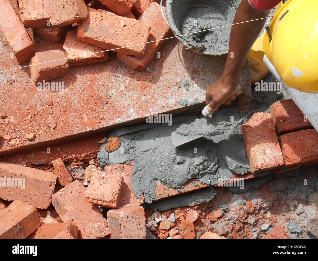 SELANGOR, MALAYSIA JANUARY 15, 2017 Bricklayer lay clay bricks block
