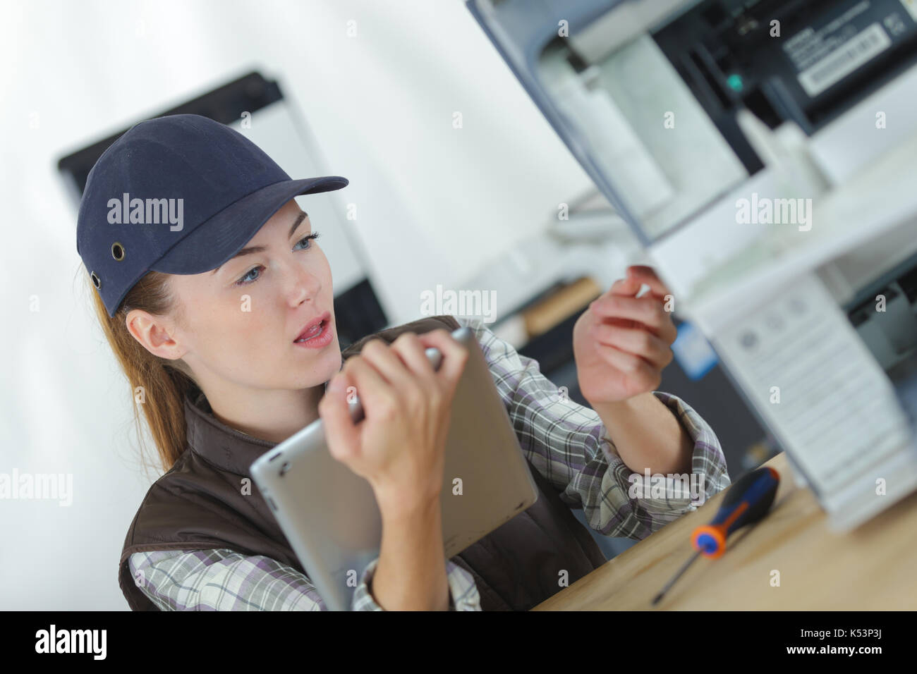 technician using tablet pc while analysing server Stock Photo