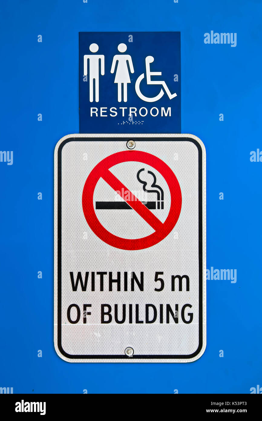 A no smoking within 5m of building sign at a reststop washroom. Stock Photo