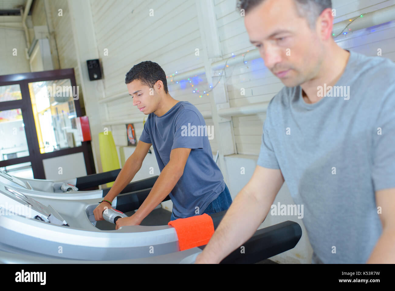 fit men using the step machine at the gym Stock Photo - Alamy